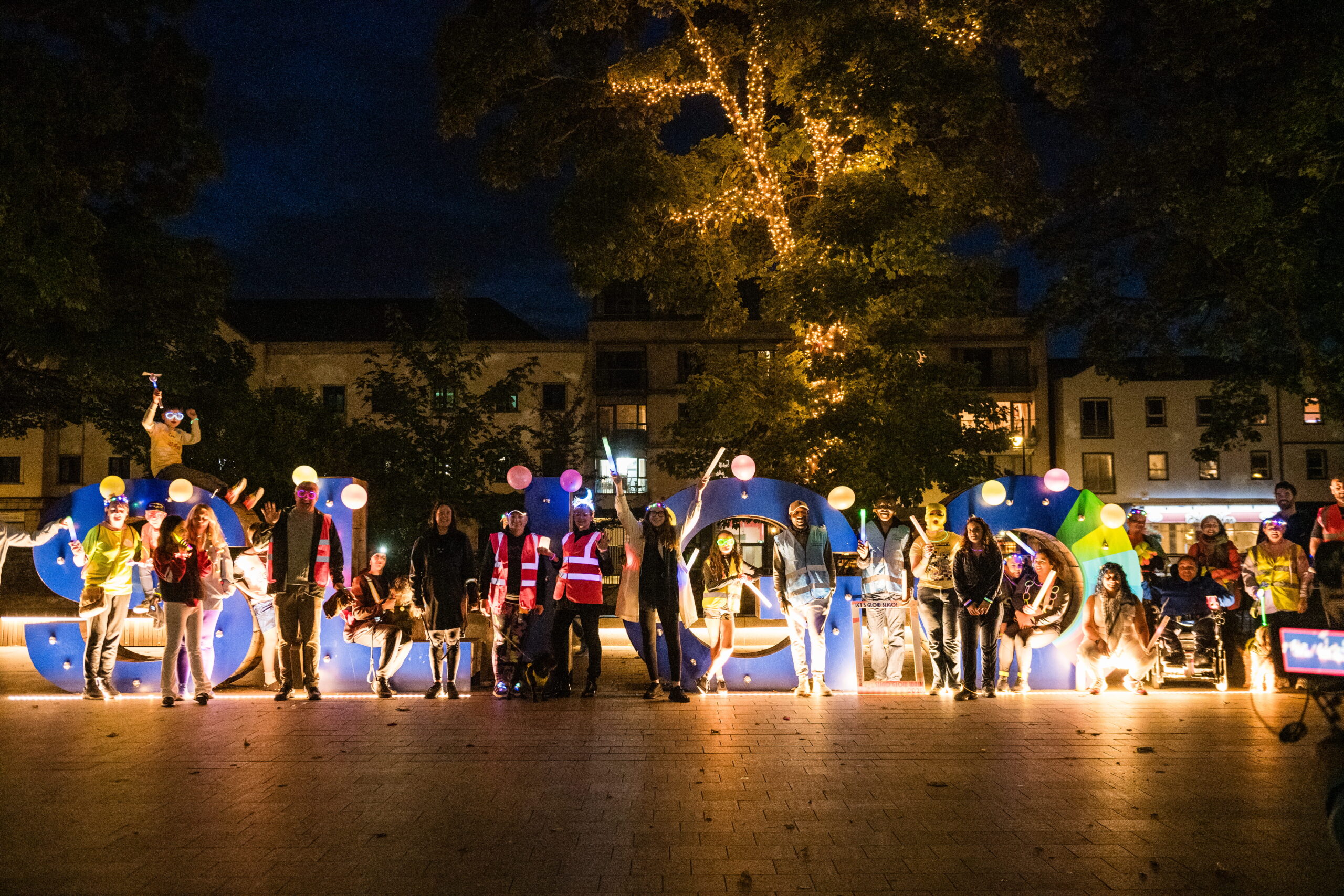 Sligo Glow Walk Participants gathered in front of Sligo sign